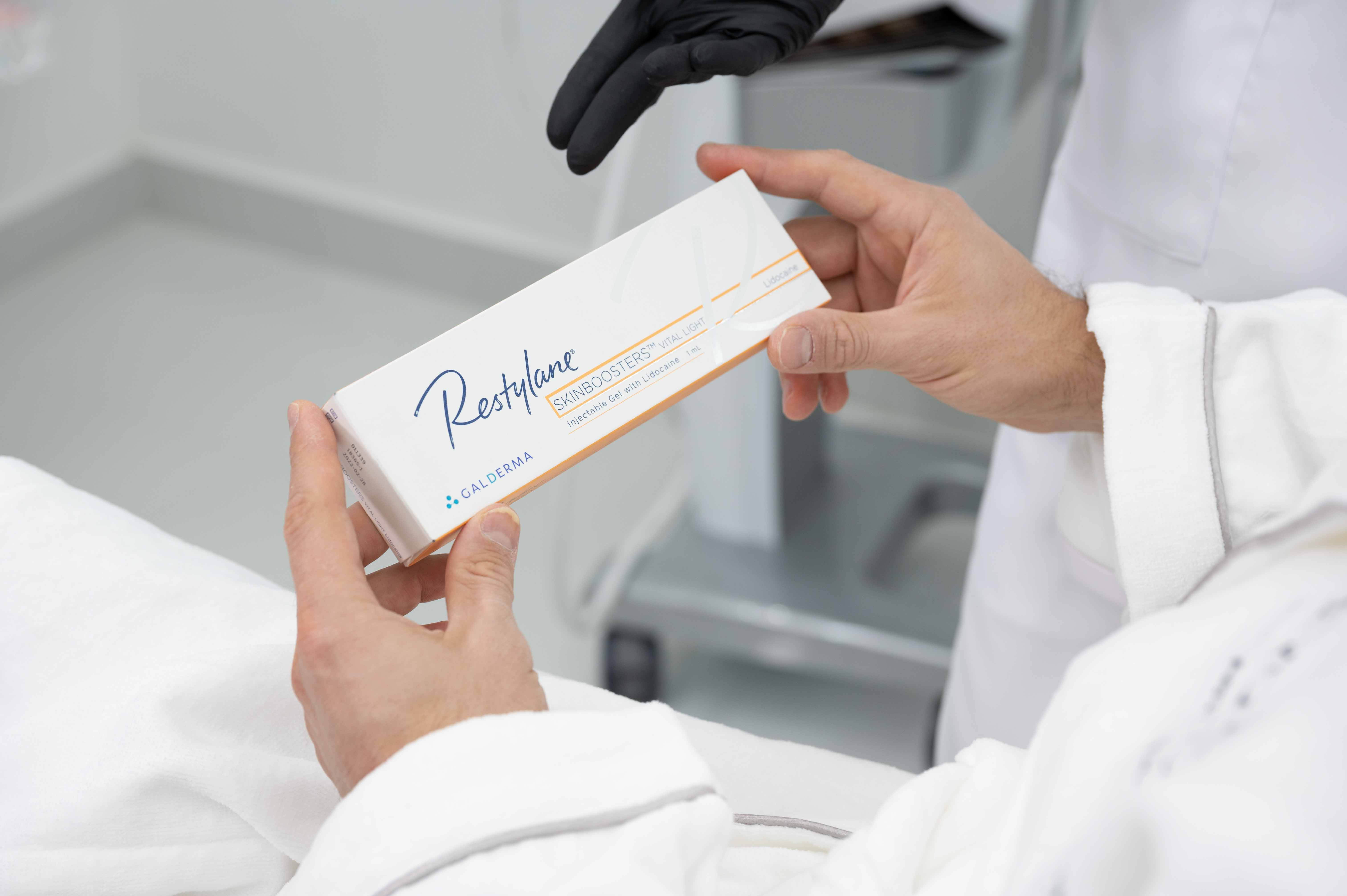 Restylane Skinboosters Vital Light packaging held during a consultation