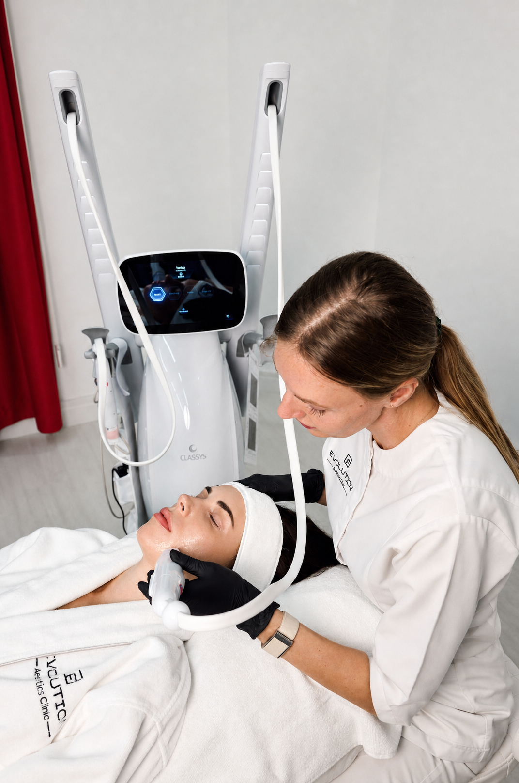 Practitioner treating a patient’s cheek with a handpiece at Evolution Aesthetics Clinic