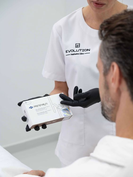 Patient holding a Profhilo box before treatment at Evolution Clinic