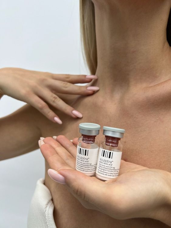 Sculptra vials held in front of a patient