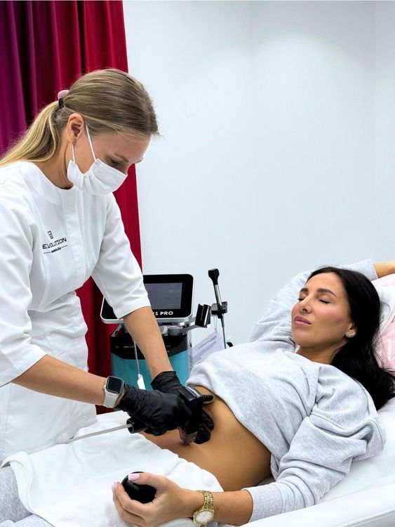 Clinician applying a UTIMS handpiece to a patient’s abdomen