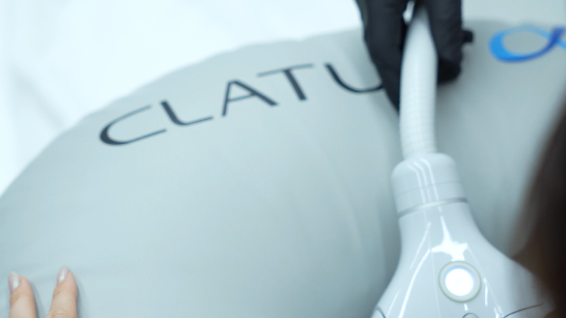 Clear CLATUU branding with clinician action; strongest device-identity shot