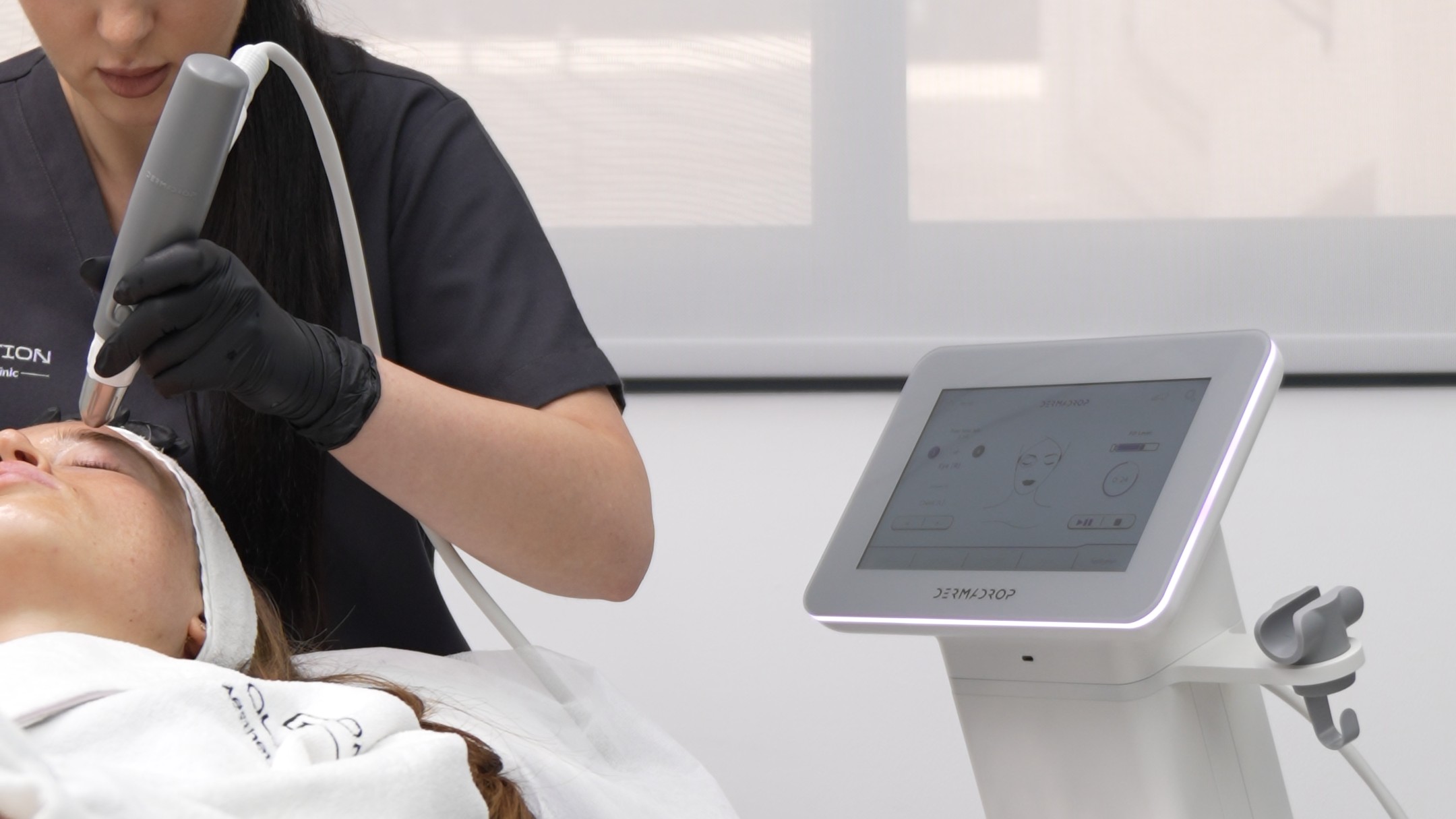 Shows the Dermadrop system and operator in one wide frame; 4K source