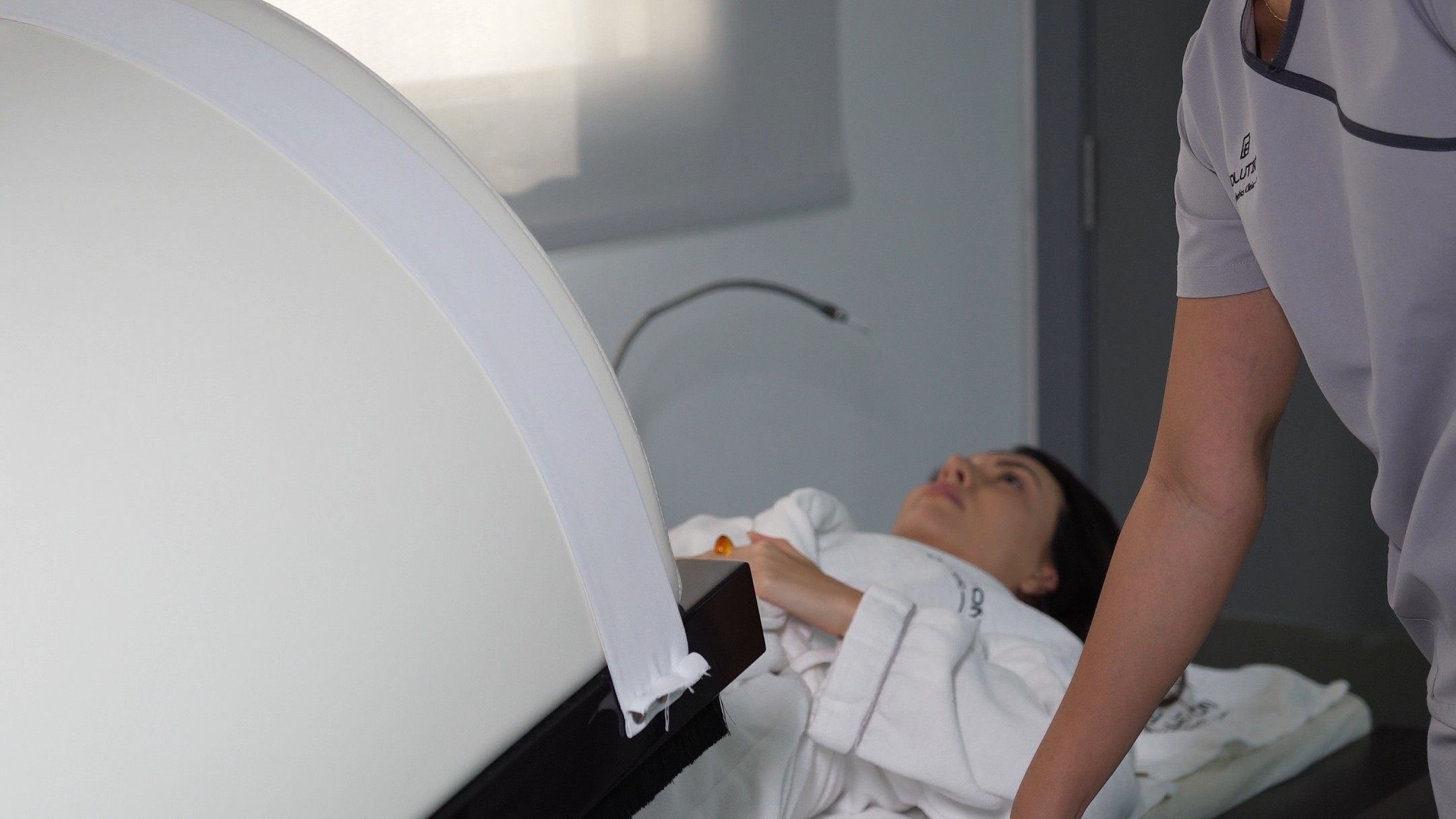 Shows the exact device, a clinician and the patient together; explains the dome format at a glance
