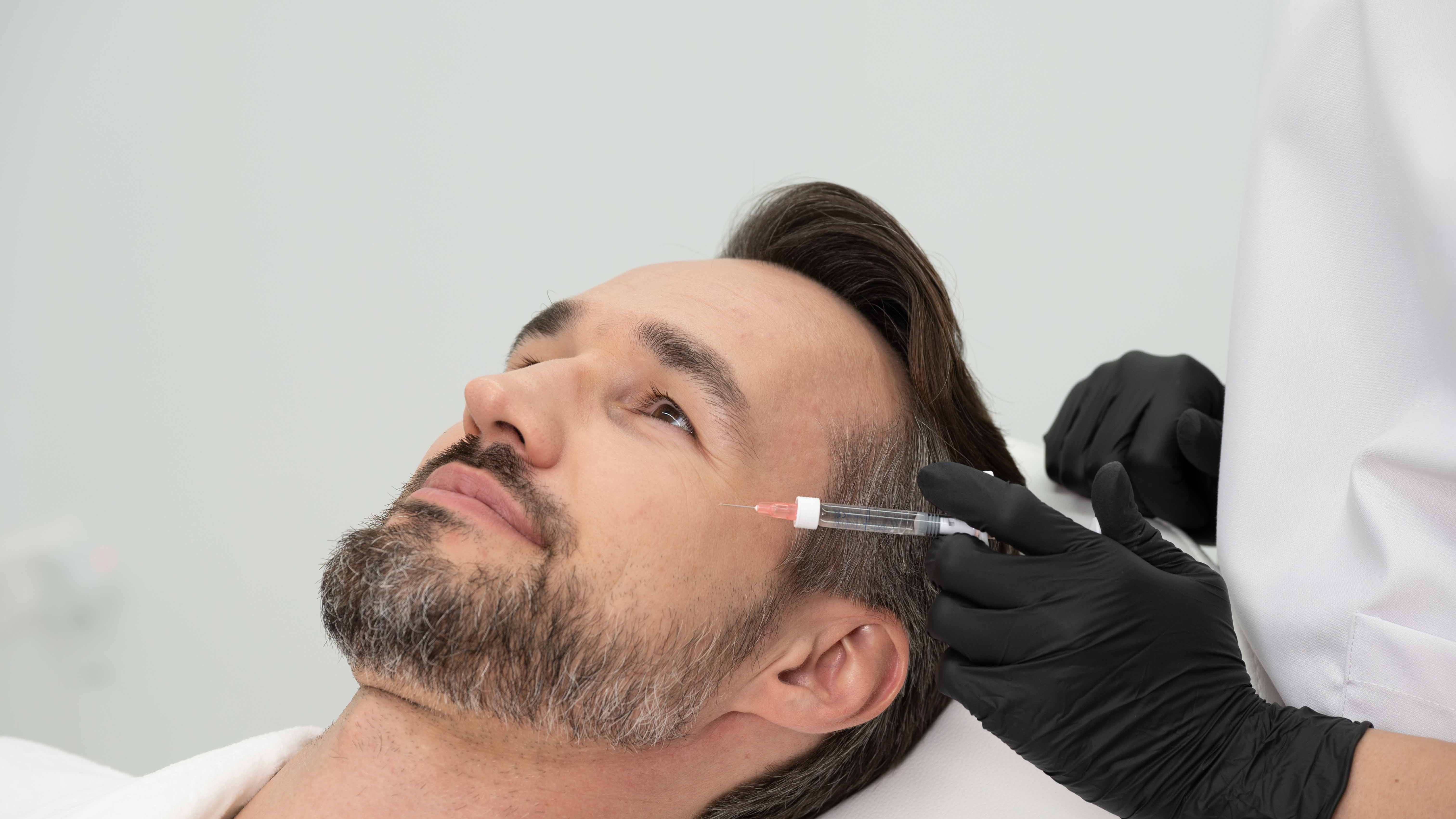 Real injection moment on the patient the Profhilo box was presented to; clean bright clinic; relaxed expression