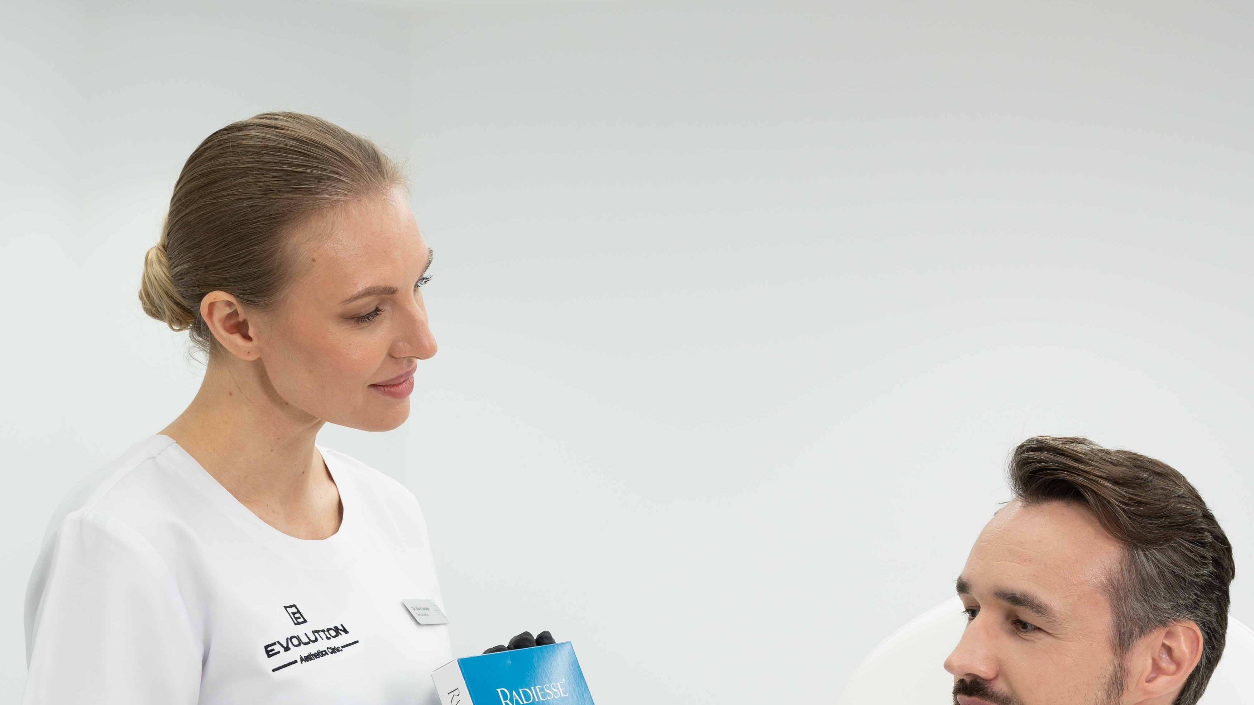 Two-person consultation with the product visible, supports the comparison theme