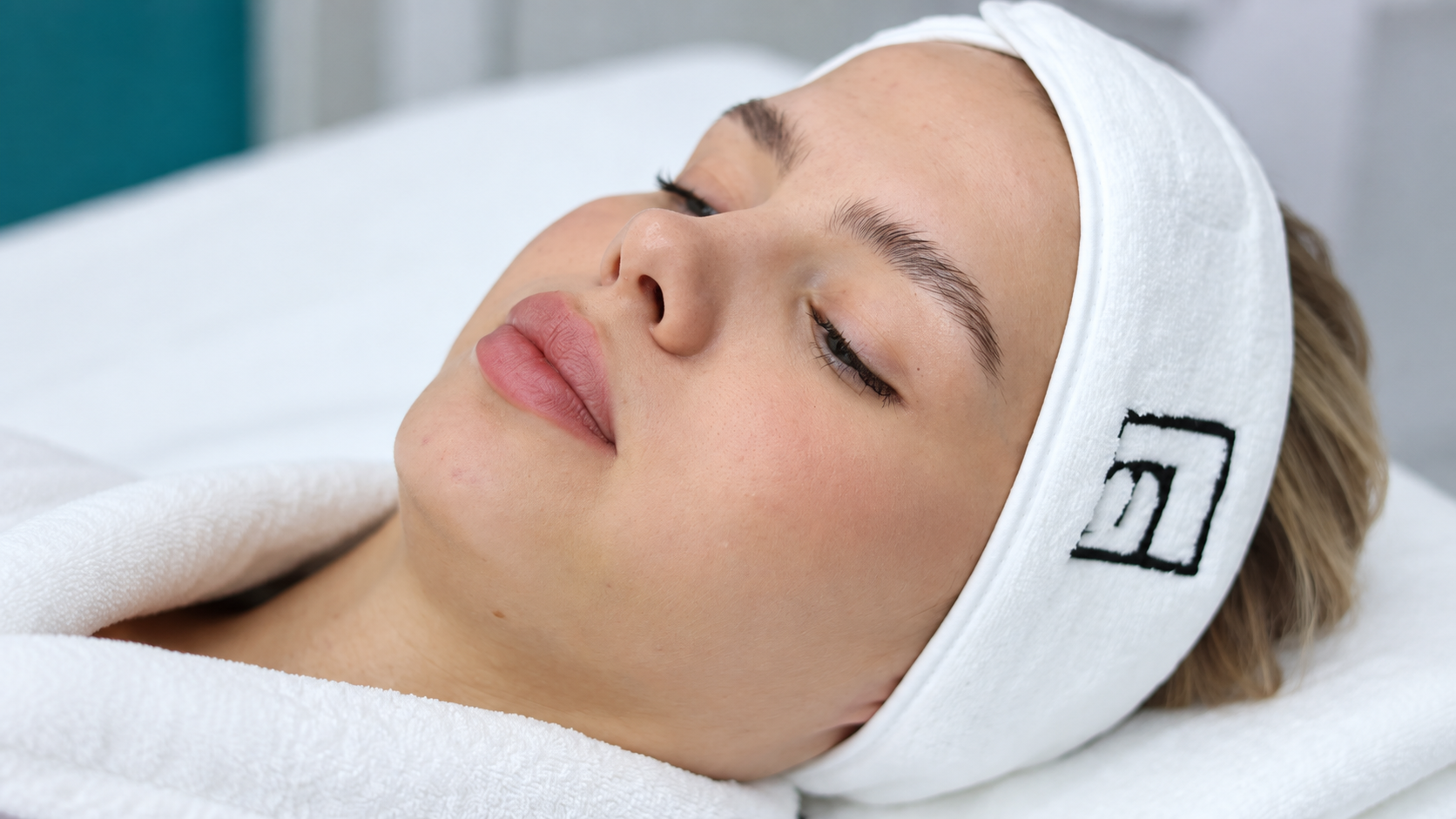 Patient resting with eyes closed at Evolution Clinic
